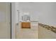 Stylish bathroom featuring neutral-toned tile, a soaking tub, and wooden vanity at 437 Via Stretto Ave, Henderson, NV 89011