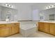 Elegant bathroom showcasing double vanities, a soaking tub, and modern fixtures at 437 Via Stretto Ave, Henderson, NV 89011