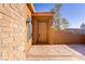 Charming front entrance with a decorative brick wall and inviting wooden door at 437 Via Stretto Ave, Henderson, NV 89011