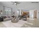 Open-concept living room with modern furnishings and a view into the kitchen at 437 Via Stretto Ave, Henderson, NV 89011