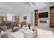 Bright living room showcases a cozy fireplace, custom built-ins, and access to the outdoor space at 437 Via Stretto Ave, Henderson, NV 89011