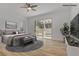 Cozy main bedroom featuring a ceiling fan, patio access, and neutral décor at 437 Via Stretto Ave, Henderson, NV 89011