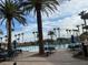 A refreshing pool area with tables, chairs, and towering palm trees for a relaxing outdoor experience at 437 Via Stretto Ave, Henderson, NV 89011