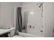 Full bathroom featuring a white tile shower-tub combo, and gray curtain at 4529 Gracemont Ave, Las Vegas, NV 89139