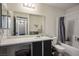 A full bathroom with a shower-tub combo, vanity, and mirrored wall at 4529 Gracemont Ave, Las Vegas, NV 89139