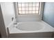 Bright bathroom showcasing a large bathtub with shower and window at 4529 Gracemont Ave, Las Vegas, NV 89139