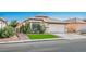 Attractive single-story home showcasing a two-car garage, manicured lawn, and vibrant landscaping at 4529 Gracemont Ave, Las Vegas, NV 89139
