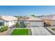 Inviting single-story home with a two-car garage, manicured lawn, and lush green shrubbery at 4529 Gracemont Ave, Las Vegas, NV 89139