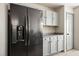 Kitchen featuring a black refrigerator, gray cabinets, and light countertops at 4529 Gracemont Ave, Las Vegas, NV 89139