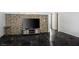 Spacious living room featuring dark tile floors and a modern media center with a large television at 4529 Gracemont Ave, Las Vegas, NV 89139