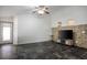 Spacious living room with dark tile floors, large windows, and a modern media center at 4529 Gracemont Ave, Las Vegas, NV 89139