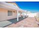 Inviting outdoor patio area featuring a covered structure, tile flooring, and privacy walls at 4529 Gracemont Ave, Las Vegas, NV 89139