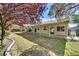 Well-maintained backyard with covered patio, mature trees, and manicured landscaping at 4624 Windy Hollow St, Las Vegas, NV 89130