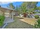 Expansive backyard features a covered patio, mature landscaping, and privacy fencing at 4624 Windy Hollow St, Las Vegas, NV 89130