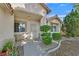 Welcoming front entrance with a security door, manicured shrubs, and desert landscaping at 4624 Windy Hollow St, Las Vegas, NV 89130