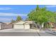 Charming single-story home with a two-car garage and a mature tree in the front yard at 4624 Windy Hollow St, Las Vegas, NV 89130