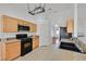 Updated kitchen with oak cabinets, granite countertops, tile floors, and modern appliances at 4624 Windy Hollow St, Las Vegas, NV 89130