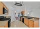 Well-equipped kitchen featuring oak cabinets, tile floors, and an open design at 4624 Windy Hollow St, Las Vegas, NV 89130