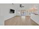 Spacious living room with a ceiling fan, modern lighting, and vinyl flooring at 4624 Windy Hollow St, Las Vegas, NV 89130