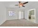 Bright main bedroom with a ceiling fan, carpet flooring, and an ensuite bathroom with a walk-in shower at 4624 Windy Hollow St, Las Vegas, NV 89130
