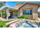 Serene backyard featuring a covered patio, a hot tub, and neatly manicured landscaping at 4937 Graziano Ave, Las Vegas, NV 89141