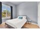 Comfortable bedroom with light hardwood flooring and natural lighting from a bright window at 4937 Graziano Ave, Las Vegas, NV 89141