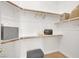 Walk-in closet with organized shelves, storage boxes, and a cushioned seat at 4937 Graziano Ave, Las Vegas, NV 89141