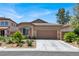 Charming single-story home with desert landscaping, a two-car garage and a tile roof at 4937 Graziano Ave, Las Vegas, NV 89141