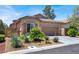 Single-story home featuring a two-car garage and desert landscaping with mature shrubs at 4937 Graziano Ave, Las Vegas, NV 89141
