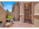 Inviting front porch with brick pavers, seating and a decorative metal security door at 4937 Graziano Ave, Las Vegas, NV 89141