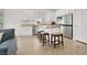 Bright kitchen featuring a center island with barstool seating and stainless steel appliances at 4937 Graziano Ave, Las Vegas, NV 89141