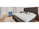 Spacious bedroom featuring a king-sized bed, a seating bench and hardwood floors at 4937 Graziano Ave, Las Vegas, NV 89141