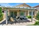Inviting covered patio with a dining area and comfortable seating, perfect for outdoor gatherings at 4937 Graziano Ave, Las Vegas, NV 89141