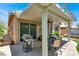 Spacious, covered patio with a grill, dining area, and lush landscaping at 4937 Graziano Ave, Las Vegas, NV 89141