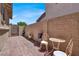 Charming outdoor space with seating area, brick pavers, and enclosed brick wall at 4937 Graziano Ave, Las Vegas, NV 89141