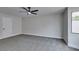 Bright bedroom features neutral walls, plush carpeting, a modern ceiling fan and a window providing natural light at 5151 Tennis Ct, Las Vegas, NV 89120