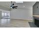 Bright living room boasts wood-look floors, vaulted ceiling, and modern fireplace at 5151 Tennis Ct, Las Vegas, NV 89120
