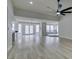 Bright, open living room with wood-look floors that flow into kitchen and dining areas at 5151 Tennis Ct, Las Vegas, NV 89120