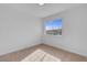 Well-lit bedroom featuring neutral carpet and a large window at 5264 Silverheart Ave, Las Vegas, NV 89142