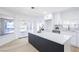 This spacious modern kitchen includes a big island with a white countertop and backyard access at 5264 Silverheart Ave, Las Vegas, NV 89142