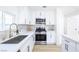 Modern kitchen with white cabinets, stainless steel appliances, and stylish backsplash at 5264 Silverheart Ave, Las Vegas, NV 89142