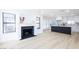 Inviting living room featuring a cozy fireplace and an open kitchen concept at 5264 Silverheart Ave, Las Vegas, NV 89142