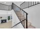 Modern staircase with plush carpeting and dark metal railing leads to second floor at 5264 Silverheart Ave, Las Vegas, NV 89142