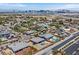 Wide aerial shot features neighborhood homes with inviting pools and stunning views of the city skyline and distant mountains at 5801 Exbury Gardens Ct, Las Vegas, NV 89118