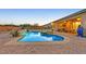 Backyard features an in-ground pool, spa and covered patio area at 5801 Exbury Gardens Ct, Las Vegas, NV 89118