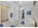 Elegant bathroom with a freestanding tub, frameless glass shower, and access to a walk-in closet at 5801 Exbury Gardens Ct, Las Vegas, NV 89118