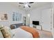 Comfortable bedroom features a comfortable bed, a sitting area, and a large window with plantation shutters at 5801 Exbury Gardens Ct, Las Vegas, NV 89118