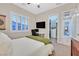 Inviting bedroom featuring a cozy bed, a dedicated workspace, and a walk-in closet at 5801 Exbury Gardens Ct, Las Vegas, NV 89118