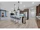 A gourmet kitchen with granite countertops, stainless steel appliances, and a center island with seating at 5801 Exbury Gardens Ct, Las Vegas, NV 89118