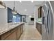 Kitchen view showcasing the granite counters, stainless steel appliances, and open floor plan into the living area at 5801 Exbury Gardens Ct, Las Vegas, NV 89118